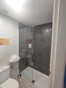 a bathroom with a shower and a toilet at Bilbao Metropolitan Hostel by Bossh! Hotels in Bilbao +77 photos