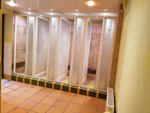 a row of glass shower doors in a bathroom at Sea Rooms ENGURE in Engure
