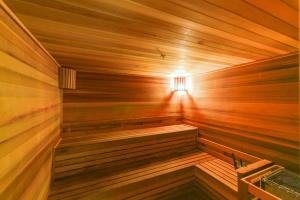 a wooden sauna with a light in it at Beautiful and Stylish Condo Close The Doral Park in Miami