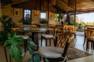 a restaurant with tables and chairs and plants at Hotel Marie Real Cartagena in Cartagena de Indias