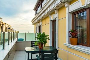 a balcony with a table and plants on it at Grand Rosa Hotel in Istanbul