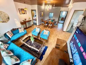 an overhead view of a living room with blue couches at Lovely 3BHK Serviced Apt near ISKCON Temple, Juhu Mumbai in Mumbai