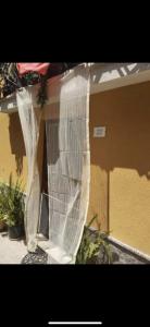 a house with a plastic wrap around the front of it at Cottage Gole Alcantara Sarino in Graniti