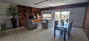a living room with a table and chairs and a kitchen at Mirador Céntrico Amplio y Soleado in Gandía