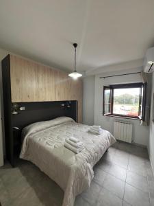 a bedroom with a large bed with towels on it at Agriturismo Cinque Novembre in Castiglione del Lago +30 photos