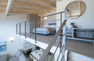 a bedroom with a bed and a staircase in a room at Pantheon Villas in Agios Nikitas +91 photos
