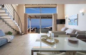 a living room with a couch and a table at Pantheon Villas in Agios Nikitas