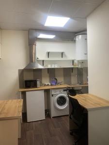 a kitchen with a washing machine and a washer at Family Hostel and Tours in Yerevan