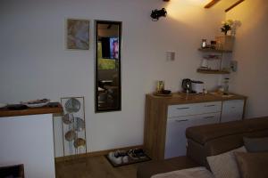 a living room with a couch and a mirror at Apartman Livada Bar in Bar