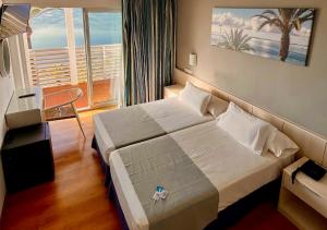 Postel nebo postele na pokoji v ubytování Hotel Neptuno