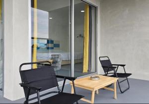 a room with two chairs and a table and a bed at 365 Resorts in Kaki Bukit