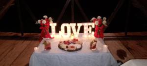 a table with a cake and a sign that says i love at La playita ocean view in Playa Blanca