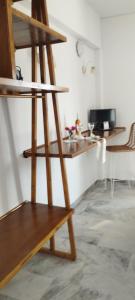 a wooden shelf in a room with a table at Παραθαλασσιο στουντιο Μιχαλιας Sea view studio Michalias Νουμερο 8 in Agia Marina Aegina +20 photos