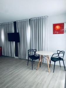 a room with two chairs and a table and a television at Cristal Palace Hotel in Buenos Aires