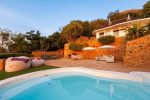 a swimming pool in front of a house at Romantic Hot Tub Retreat - Enso Botanico Boutique Villa 1, Kosmos in Hartbeespoort