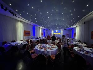 a large room with tables and chairs with people in it at Cristal Palace Hotel in Buenos Aires