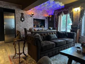 a living room with a couch and a table at LA CHAMBRE DES SECRETS, Magique, Hyper-centre, 9 Couchages in Mâcon