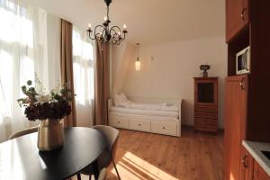 a living room with a table and a bed at Apartmá Justina 1880 in Karlovy Vary