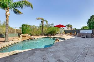 a swimming pool in a yard with a palm tree at 3 Mi to Usery Mtn Regional Park Poolside Paradise in Mesa