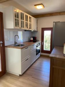 a kitchen with white cabinets and a sink at Villa Valeria in Solanas +11 photos