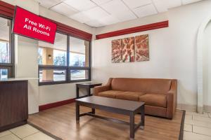 a waiting room with a couch and a coffee table at Red Roof Inn Montgomery - Midtown in Montgomery
