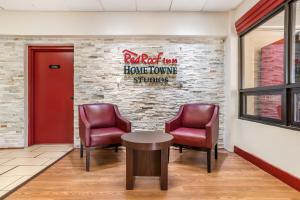 a waiting room with two chairs and a red door at Red Roof Inn Montgomery - Midtown in Montgomery