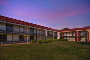 an exterior view of a building with a yard at Red Roof Inn Montgomery - Midtown in Montgomery