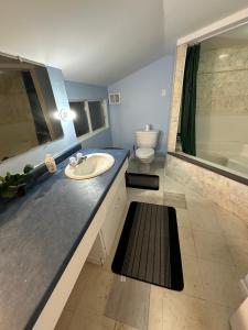 a bathroom with a sink and a toilet and a tub at Thessalon Luxury House -Space Share in Thessalon +45 photos