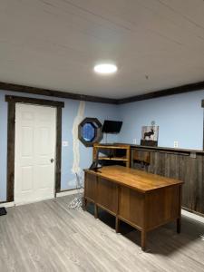 a room with a desk and a white door at Thessalon Luxury House -Space Share in Thessalon