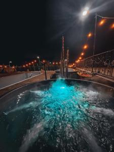 a pool of water at night with lights in it at Pensiunea PORTAS RESORT in Slănic