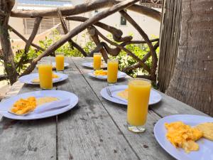 a table with plates of food and glasses of orange juice at La playita ocean view in Playa Blanca +31 photos