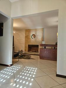 a living room with a fireplace and a tile floor at Casa Garay Hotel 658 in Asuncion