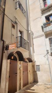 a entrance to a building with a wooden door at La Maison De Poupée in Bari