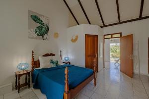 a bedroom with a bed with a blue comforter at Village Honoré in Saint-François +85 photos