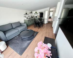 a living room with a couch and a table at Logis du Boutillier in Vivonne