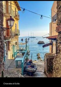 a view of the ocean from between two buildings at Casa tra gli ulivi a Motta San Giovanni vacanza in Reggio Calabria in Motta San Giovanni