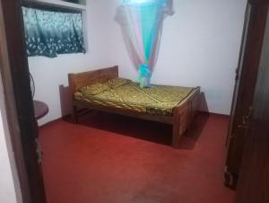 a small bed in a room with a window at My room at Galle in Galle