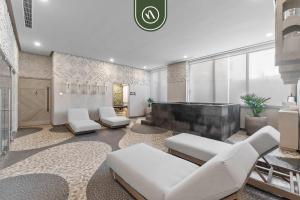 a living room with white furniture and a large window at Luxury 2 BR Condo with Dream Pools - Beach - Art in Bucerías