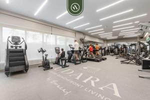 a gym with tread machines and people in it at Luxury 2 BR Condo with Dream Pools - Beach - Art in Bucerías +45 photos