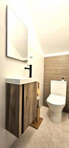 a bathroom with a white toilet and a sink at Praia da Rocha in Portimão