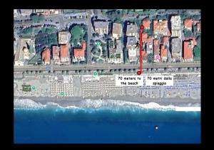a map of a beach with a red arrow at Varigotti Tropical Garden - full floor apartment in Varigotti