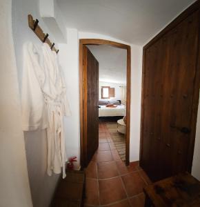 a hallway with a door to a room with a bed at Cortijo El Ancla in Albox +16 photos