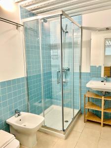 a bathroom with a shower and a toilet and a sink at Loft Manuel Arellano in Seville