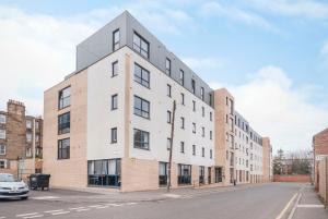 un edificio blanco alto en una calle de la ciudad en Beaverbank Place - Campus Residence, en Edimburgo