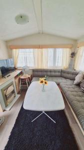 a living room with a couch and a table at 6 Guests - 3 Bedrooms - Entertainment - Near Beach in Sheerness