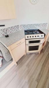 a kitchen with a stove and a counter top at 6 Guests - 3 Bedrooms - Entertainment - Near Beach in Sheerness