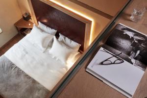 Postel nebo postele na pokoji v ubytování Domus Renier Boutique Hotel