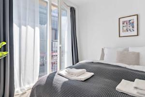 a bedroom with a bed with two towels on it at Superb First-Floor Mid Town Apartment in Aarhus +25 photos