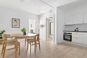 a kitchen and dining room with a table and chairs at Superb First-Floor Mid Town Apartment in Aarhus