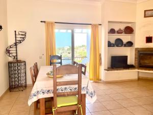 a dining room with a table and a fireplace at Villa Ana in Albufeira +35 photos